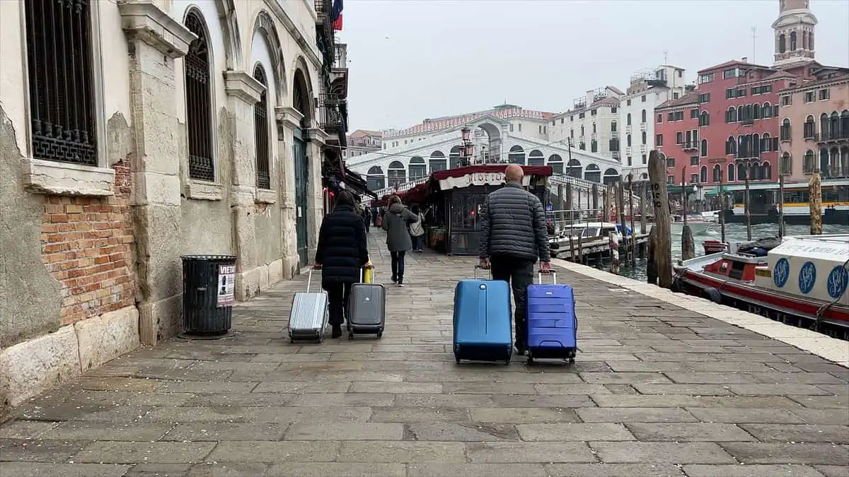 tourists in Venice with big bags